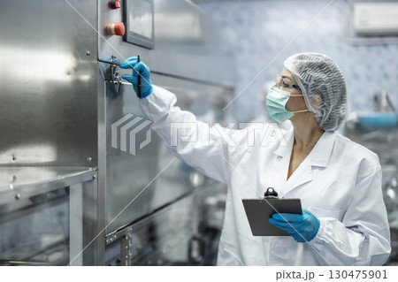 Industry inspector team working, QC staff work checking machine operation for safety and hygiene 130475901