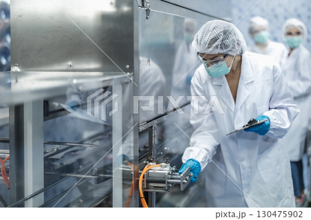 Industry inspector team working, QC staff work checking machine operation for safety and hygiene Industry inspector team working, QC staff work checking machine operation for safety and hygiene 130475902