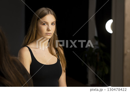 Young woman with long straight hair and natural makeup posing Young woman with long straight hair and natural makeup posing 130478422
