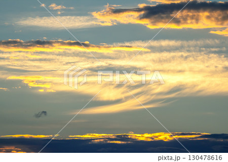 Colorful sunset sky with clouds creating vibrant patterns over the horizon 130478616