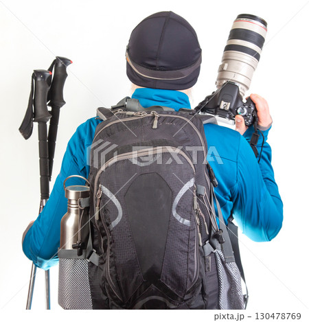 Adventurer prepares for outdoor exploration with camera and hiking gear in a studio setting Adventurer prepares for outdoor exploration with camera and hiking gear in a studio setting 130478769