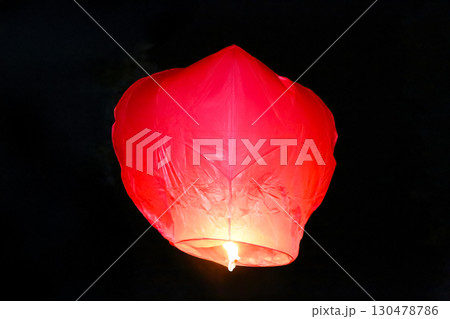Red lantern floating in the night sky during a festival celebration Red lantern floating in the night sky during a festival celebration 130478786