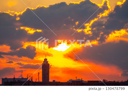 Stunning sunset over historic tower with dramatic clouds in the evening sky 130478799