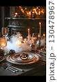 Carved pumpkin centerpiece surrounded by flickering candles, smoky ambiance, and glowing string lights preparing festive Halloween dinner table decor 130478967