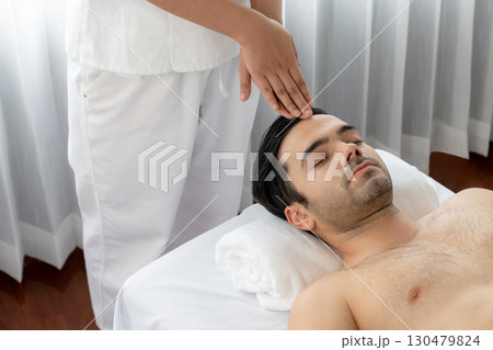 Caucasian man enjoying relaxing anti-stress head massage. Quiescent 130479824