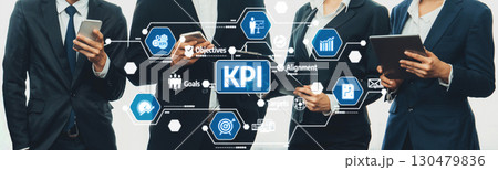 Business Professionals Analyzing Key Performance Indicators and Strategic Goals with Digital Tools in Modern Office Environment. Amity Business Professionals Analyzing Key Performance Indicators and Strategic Goals with Digital Tools in Modern Office Environment. Amity 130479836