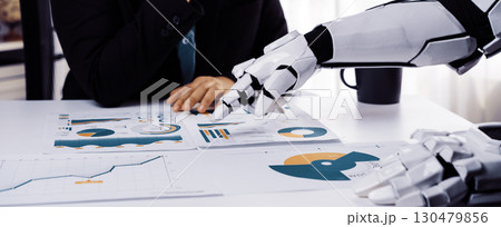 Human and Robot Collaboration in Business, Analyzing Data Reports with Charts and Graphs in a Modern Office Environment. Noogenesis Human and Robot Collaboration in Business, Analyzing Data Reports with Charts and Graphs in a Modern Office Environment. Noogenesis 130479856