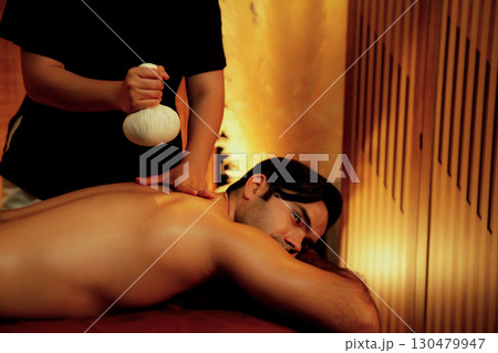 Hot herbal ball spa massage body treatment with couple customer. Quiescent 130479947