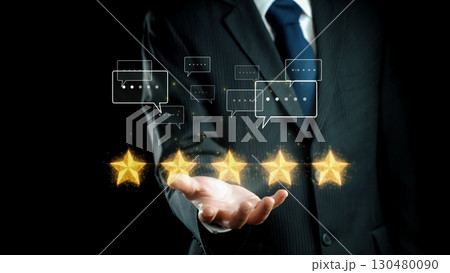 Business Professional Presenting Five Star Ratings with Customer Feedback Icons on a Dark Background for Review and Rating Concepts. Qubit 130480090