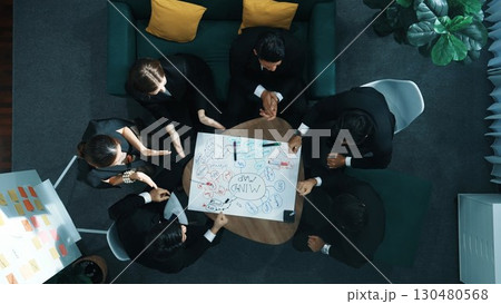 Top view of people putting hands together while using mind map. Directorate. 130480568