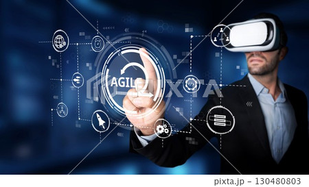 Businessman in Virtual Reality Glasses Exploring Innovative Agile Technology Concepts in Futuristic Digital Environment with Graphical User Interface Elements. Raster Businessman in Virtual Reality Glasses Exploring Innovative Agile Technology Concepts in Futuristic Digital Environment with Graphical User Interface Elements. Raster 130480803