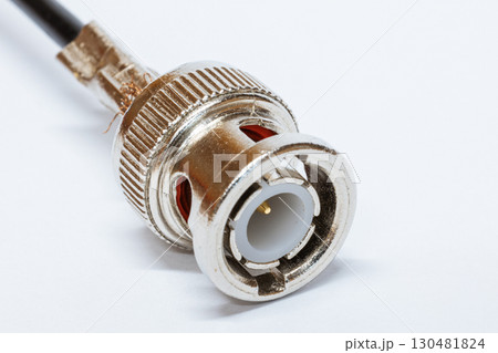 Macro photo of BNC connector on white background. Metal connector with central contact used for coaxial cables in video communication and radio equipment. BNC connector crimping. Macro photo of BNC connector on white background. Metal connector with central contact used for coaxial cables in video communication and radio equipment. BNC connector crimping. 130481824