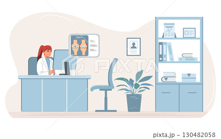 Doctor in office using computer at desk with anatomical poster on wall in medical background 130482058