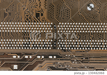 Macro macro photography of motherboard with copper tracks and soldering. Lots of connections and contact points. Abstract technical structure, Textalite and electronics parts. Macro macro photography of motherboard with copper tracks and soldering. Lots of connections and contact points. Abstract technical structure, Textalite and electronics parts. 130482068
