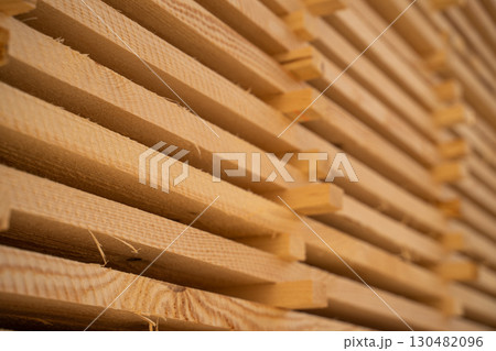 Close-up of stacked wooden boards in sunlight Close-up of stacked wooden boards in sunlight 130482096