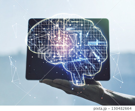 Digital Brain Innovation: A hand gracefully holds a digital tablet, from which a luminous, intricately designed brain composed of interconnected nodes and lines emerges. 130482664