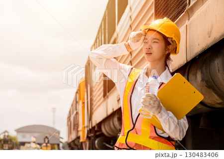 Young lady engineer worker feel tired exhausted from hard working outdoor hot UV in sunny summer day Young lady engineer worker feel tired exhausted from hard working outdoor hot UV in sunny summer day 130483406