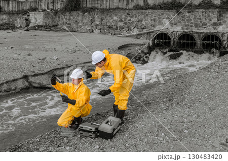 Water Pollution Control. Scientist team checking water quality from industry wastewater sewage river impact from danger toxic and chemical release 130483420