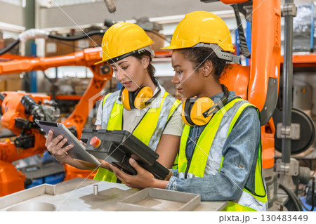 robotic engineer training, technician work in factory industry robot welding arm machine control 130483449