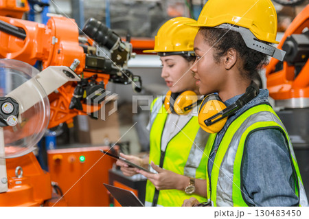 robotic engineer training, technician work in factory industry robot welding arm machine control 130483450