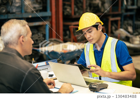 Technician engineer man working at desk calculate cost expense for metal spare part to customer in industry market Technician engineer man working at desk calculate cost expense for metal spare part to customer in industry market 130483488