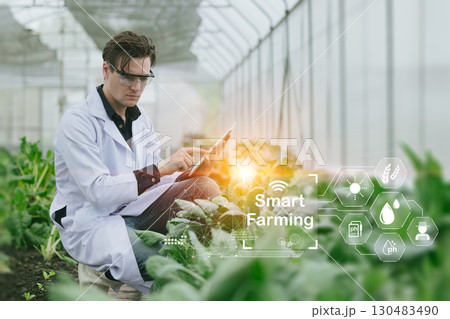modern farmer using Smart Farming, Farming technology innovation software for new agriculture plant monitor control. modern farmer using Smart Farming, Farming technology innovation software for new agriculture plant monitor control. 130483490