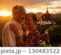 Elderly couple embraced happily smiling in front of temple at sunset 130483522