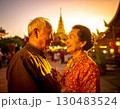 Elderly couple embraced happily smiling in front of temple at sunset 130483524