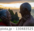 Elderly couple embraced happily smiling in front of beautiful landscape. 130483525