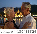 Elderly couple embraced happily smiling in front of temple at sunset 130483526
