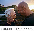 Elderly couple embraced happily smiling in front of beautiful landscape. 130483529