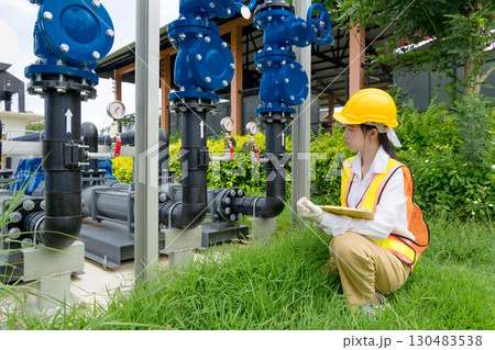 Engineer technician check new install progressing cavity pumps and water valve pipe system outdoor 130483538