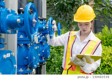 Engineer technician check new install progressing cavity pumps and water valve pipe system outdoor 130483539