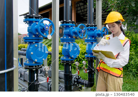 Engineer technician check new install progressing cavity pumps and water valve pipe system outdoor 130483540