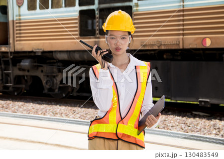 Portrait Asian young teen engineer worker work in Train station, Locomotive service station Portrait Asian young teen engineer worker work in Train station, Locomotive service station 130483549