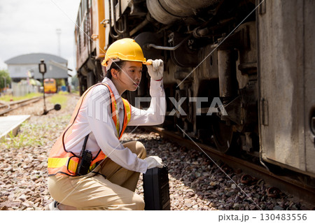 Asian young teen engineer worker work in Train station, Old locomotive service maintenance Asian young teen engineer worker work in Train station, Old locomotive service maintenance 130483556