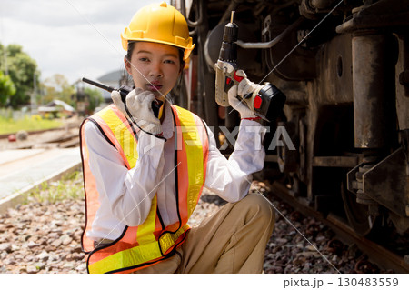 Asian young teen engineer worker work in Train station, Old locomotive service maintenance Asian young teen engineer worker work in Train station, Old locomotive service maintenance 130483559