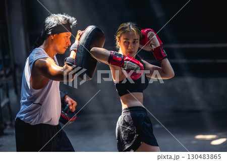 Thai boxing, Women fighter training kick boxing with trainer in ruin building ,Asian martial arts 130483865