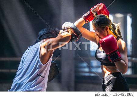 Thai boxing, Women fighter training kick boxing with trainer in ruin building ,Asian martial arts 130483869
