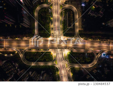 Night aerial view showcases city traffic interchange with lighted roadways in urban landscape of Hangzhou, China. 130484537