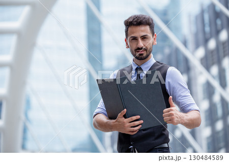 Portrait Hispanic Indian business man confident thumbs up with folder for business project approved Portrait Hispanic Indian business man confident thumbs up with folder for business project approved 130484589