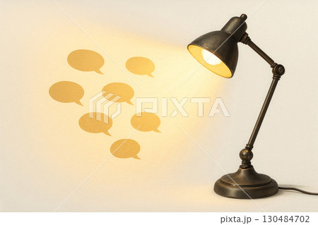 A table lamp that emits light in the form of chat bubbles. A table lamp that emits light in the form of chat bubbles. 130484702