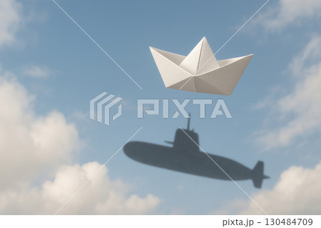 A paper ship with the shadow of a submarine. Space for text. 130484709