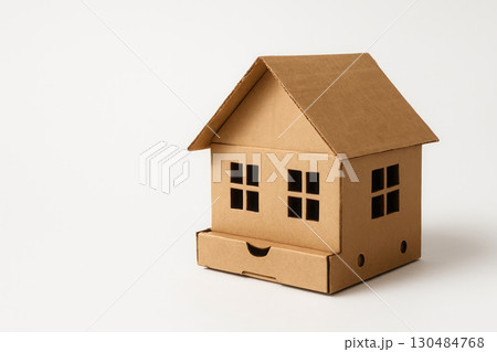 A cardboard house with a smiling face. Space for text. 130484768