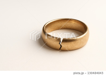 A broken wedding ring, a symbol of the end of the union. Space for text. A broken wedding ring, a symbol of the end of the union. Space for text. 130484843