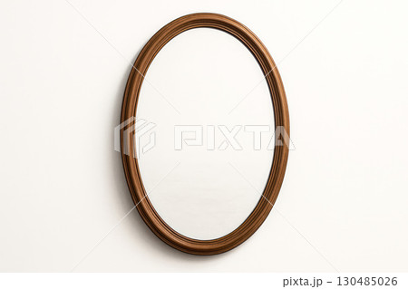 An empty oval mirror in a wooden frame on a white background. An empty oval mirror in a wooden frame on a white background. 130485026