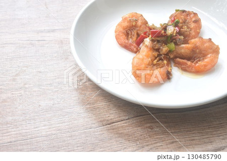 deep fried salty river shrimp with chop garlic and chili pepper arranging on plate  130485790