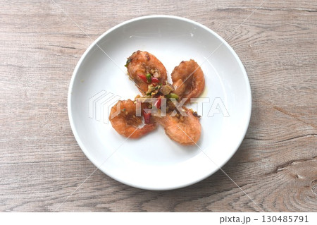 deep fried salty river shrimp with chop garlic and chili pepper arranging on plate  130485791