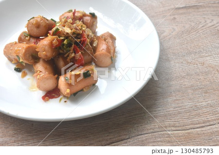 deep fried salty pork sausage with chop garlic and chili pepper arranging on plate deep fried salty pork sausage with chop garlic and chili pepper arranging on plate 130485793