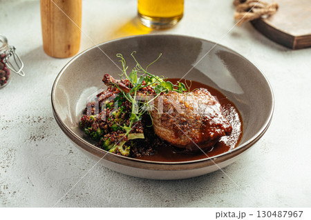 Grilled duck leg with quinoa and green vegetables 130487967